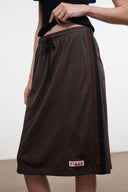 Dark brown midi skirt with drawstring waist and side panels, small logo patch