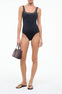 Black one-piece swimsuit with scoop neckline and studded wide straps