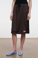 Dark brown midi skirt with drawstring waist, textured fabric and small hem logo