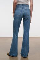 Blue flare jeans back close-up with rear yoke and stitched patch pockets