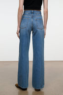 Blue wide-leg denim jeans with belt loops, front patch pockets, straight hem