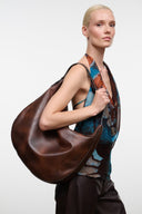Distressed espresso brown leather hobo bag, rounded slouchy body with short handles