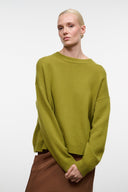 Relaxed cashmere crewneck sweater in green with ribbed hem and long sleeves.