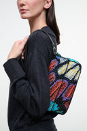Convertible shoulder bag side view with black strap and multicolor sequin butterfly artwork