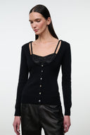 Black cashmere sweater with square neckline, strap trim, and buttoned placket