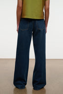 Relaxed-fit dark blue jeans with two front patch pockets and wide leg opening.