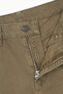Greige jeans close-up of zip fly with logo patch and inner waistband