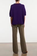 Taupe straight-leg jeans, back view with yoke seam and patch pockets