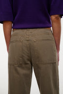 Taupe jeans with front patch pockets and visible double-stitched seams