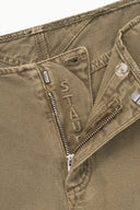 Greige jeans close-up: zipper fly, metal button, and contrast stitching