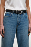 High-rise blue denim jeans with black belt, button closure, front patch pocket