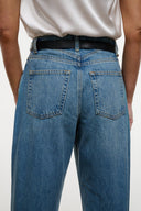 High-rise blue denim jeans with black belt, back patch pockets, belt loops
