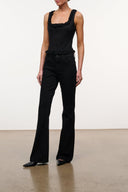 Black flare jeans with wide legs, button front, belt loops, and front pockets