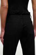 Black wide-leg jeans with front pockets, visible seams, and belt-loop waistband