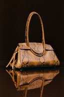 <p>A sleek, medium-sized bag with an elongated oval top handle that slips effortlessly over the shoulder</p>