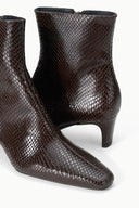 Espresso brown snake-textured ankle boot pair with mid block heel and curved toe