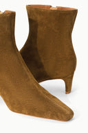 Cigar suede ankle boot showing low stacked heel and angled toe