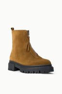 Cigar-brown zip ankle boot with short side zip, pull tab, and chunky black lug sole