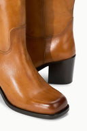 Cashew brown mid-calf boot with dark sole and black block heel