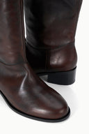 Over-the-knee boot shaft in dark espresso distressed leather with low block heel