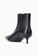 Black ankle boot with side zipper, pointed toe, and slim kitten heel