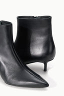 Pair of black ankle boots with pointed toe and slim kitten heel