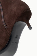 SEBASTIAN AKL suede ankle boot close-up: side zipper and kitten heel with logo