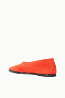 Orange suede flat slip-on shoe with low profile black sole