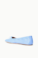 Light blue slip-on flat shoes with bow detail at toe and rounded vamp