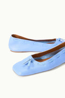 Light blue flat ballet flats with bow and decorative cutout stitching