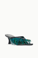 Black kitten-heel mule with teal feather detail along the open toe