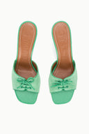Seafoam suede mule heels with lace bow, open toe, and tan sole underside