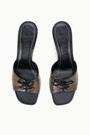 Pair of black distressed mule heels with lace bow at the front