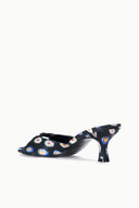 Black floral mule slide with low kitten heel, open back and patterned upper