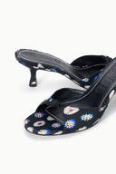 Black floral mule with low kitten heel, close-up of printed fabric upper