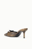 Black distressed mule in side view, pointed toe, slim stiletto heel, lace-up bow detail