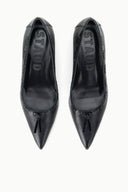 Black pointed-toe kitten heel pumps, top view showing bow and stitched vamp.