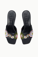 Pair of black mules with colorful bead-embroidered straps, open back, heel view