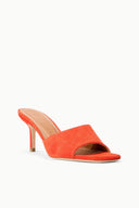 Orange suede mule sandal with open toe and slim stiletto heel, cushioned slip-on fit.
