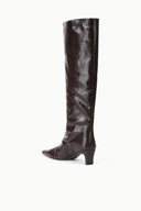Three-quarter view of dark espresso brown knee-high snake-embossed boot with low heel.