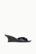 Black leather wedge slide sandals with open toe and crossover upper