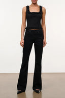Black flare jeans with wide legs, front pockets, and ruffle detail at the waist