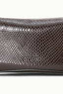 EVE clutch close-up: dark brown embossed snake pattern with smooth trim edge