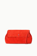 Tangerine-orange oversized flap bag with front tab and visible metal snap.
