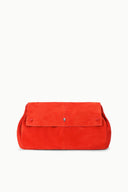Tangerine-orange oversized flap bag, front view with metal snap detail.