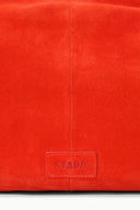 Tangerine-orange bag with front logo patch labeled STAUD on the lower panel.