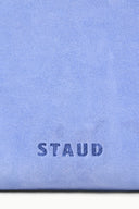 Light blue fabric close-up with 'STAUD' logo printed on the front