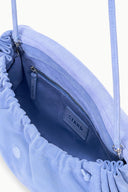 Light blue convertible bag interior with zip pocket and 'STAUD' logo patch