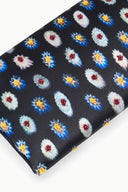 Navy fabric clutch close-up with multicolor rosette floral print