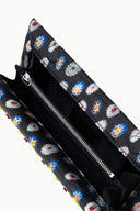 Floral-lined clutch interior with zip pocket and dark fabric opening